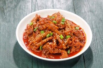 Dakbal (닭발) is a Korean dish made from chicken feet, often spicy, sweet, and chewy, which is popular as a snack or street food.