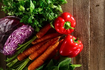 Fresh assortment of colorful vegetables on a rustic wooden surface