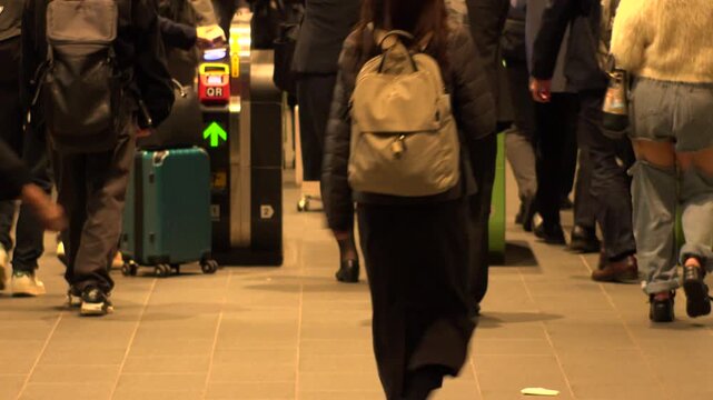 TOKYO, JAPAN - NOV 2025 : Automatic ticket gate at the train station. Crowd of people passing through the gate in busy rush hour. Japanese urban city life, transportation, traffic and commute concept.