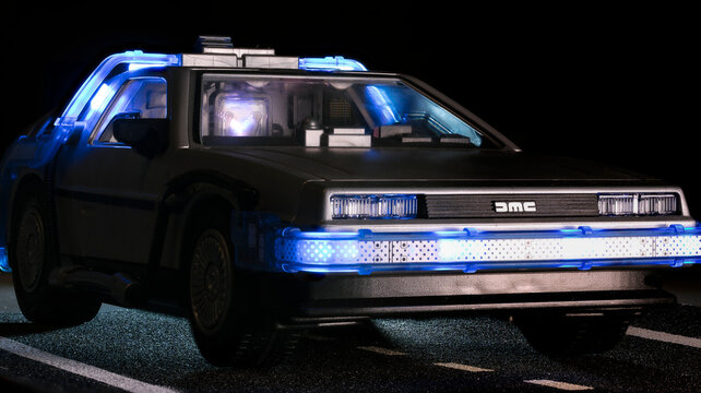 Madrid, Spain; October 25, 2025: Playmobil DeLorean toy from Back to the Future, front side glowing with blue light, detailed view of headlights and flux capacitor inside