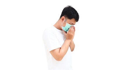 A young asian male with a surgical mask sneezing or coughing into his arm. Concept of respiratory infection, health protection, and medical prevention.