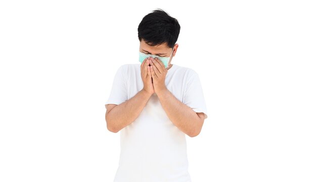 An asian man wearing a surgical mask sneezing into his hands, showing symptoms of cold or flu. Concept of infection prevention, hygiene awareness, and respiratory health protection. - Powered by Adobe