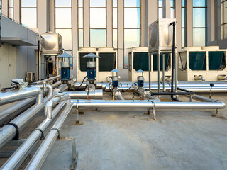 Modern Industrial Chilled Water System with Pipes and Equipment Under City Skyline