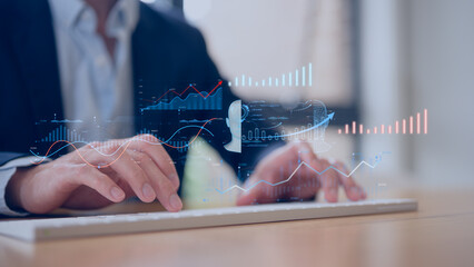 person types on a keyboard in Business performance kpi metrics visualized on smart dashboard with charts showing sales growth and indicators for productivity tracking and digital success analysis