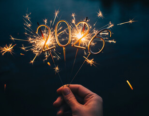 2026 Sparkler Numbers Held by Hand with Glowing Fireworks