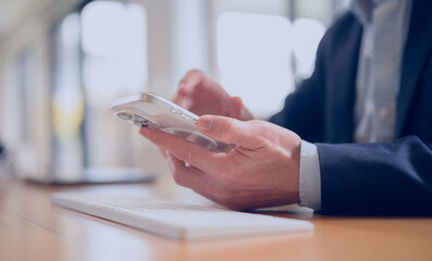 Closeup shot of businessman using smartphone cellphone. Social media marketing concept. hand using smartphone typing, chatting conversation in chat box icons pop up