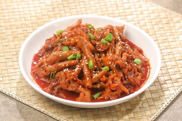 Dakbal (닭발) is a Korean dish made from chicken feet, often spicy, sweet, and chewy, which is popular as a snack or street food.