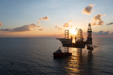 Fototapeta premium Offshore jack up rig in aerial view in the middle of the ocean taken by a drone