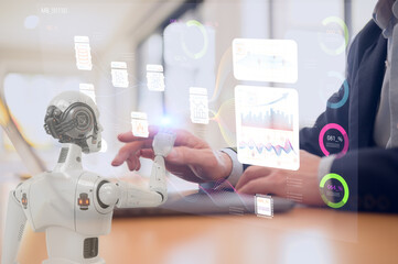 Man and AI humanoid robot using laptop work together and collaborating AI agent work with AI Financial management technology.Advisor using KPI Dashboard on virtual screen working with robot