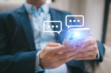 Social Media businessman hand using smartphone typing live chat chatting on application communication digital web and social network concept. Social media application chat box