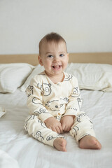 Fototapeta premium Portrait Joyful baby in bear print pajamas