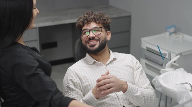 Dentist and patient interaction highlights comfort and care at modern dental clinic