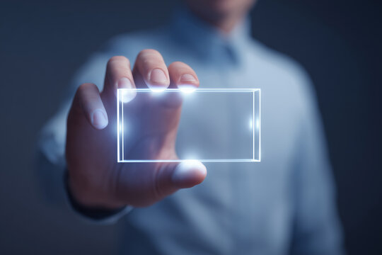 Caucasian middle aged man in blue shirt presenting holographic glowing rectangle, concept for futuristic business card or digital identity