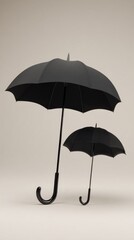 Two black umbrellas standing on neutral beige background with minimalist composition ideal for insurance concepts, design posters and product advertising