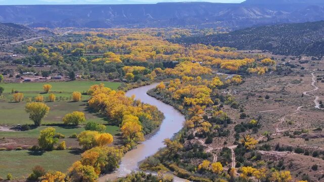 Serene view of Rio Chama with fall foliage in Abiquiu, New Mexico