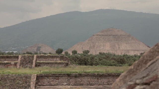 Long shot of the ancient Pyramids of Teotihuacan in Mexico, showcasing the grandeur of this historic Mesoamerican city under daylight.