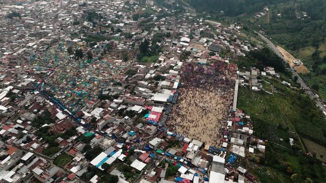 Aerial view of Sumpango kite festival beside colorful cemetery on All Saints Day