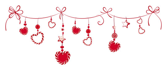 New Year's ribbon garland with red festive decor is adorned with bows. Various sweet candies and lollipops hang from the ribbon. The bright Christmas decor is isolated on white background.