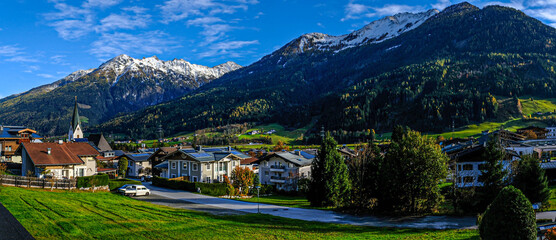 The village of Neukirchen am Grossvenediger at the foot of snow-covered mountains in Austria