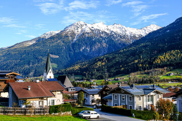 The village of Neukirchen am Grossvenediger at the foot of snow-covered mountains in Austria