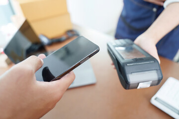 Digital Payment. Customer using smartphone for contactless payment.