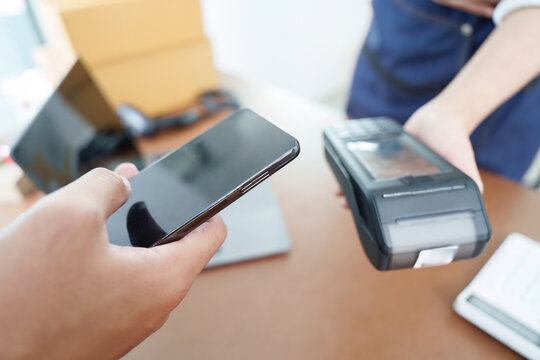 Digital Payment. Customer using smartphone for contactless payment.