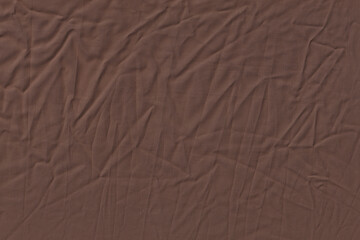 Rich Dark Brown Wrinkled Fabric or Crumpled Textile Background Texture.
