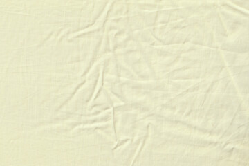 Cream or Off-White Wrinkled Cotton Fabric, Soft Bed Sheet Texture Background.