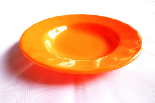 orange plastic plate from isolaed on white