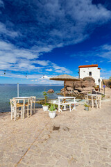 Picturesque seaside landscape with a chapel on a rock, on the Greek volcanic island of Lesbos, background or wallpaper from the project