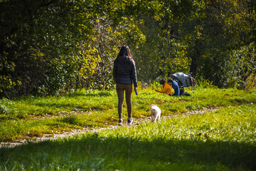 Autumn scenes captured from ground level in Małopolska, Poland. People walking along paths, colorful foliage, riverside views and rural landscapes under dramatic skies.