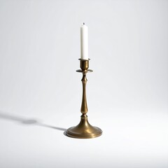 Brass candle holder with white candle on plain background