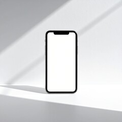 Black phone with blank screen on white, sunlight shadow