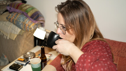 A woman drinking coffee at home