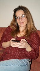 Portrait of a nerdy woman with a mobile phone