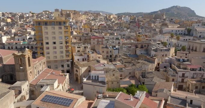 Aerial view of houses, apartments, and buildings in the historic center of Sciacca, in the province of Agrigento, Sicily, Italy. It's a beautiful, sunny summer day.