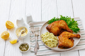 roast chicken legs with coleslaw on a plate