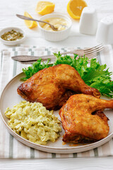 roast chicken legs with coleslaw on a plate