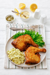 roast chicken legs with coleslaw on a plate