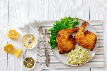 roast chicken legs with coleslaw on a plate