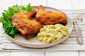 roast chicken legs with coleslaw on a plate