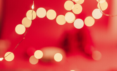 Festive red background with multiple lights, soft focus, bokeh.