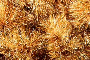 Golden tinsel Christmas tree bokeh background. Festive pattern. Xmas holiday spirit.