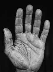 Detailed black and white image of a dirty human hand