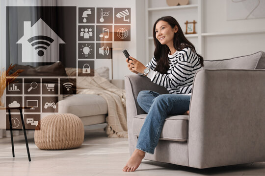 Smart home. Different icons on virtual screen and happy woman using mobile phone in room