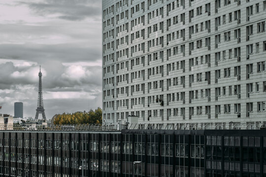Aerial view over urban city skyline with residential apartments and modern office architecture buildings in Paris under diffuse daylight