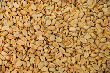 A background of salted roasted peanuts. Lots of peeled peanuts, top view.