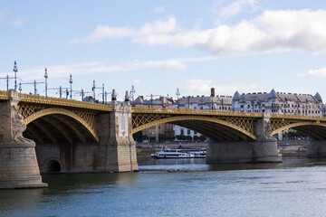 Fototapeta premium Low angle view of the 1876 stone and golden metal Margaret Bridge connecting Buda and Pest over the Danube River seen during a sunny day