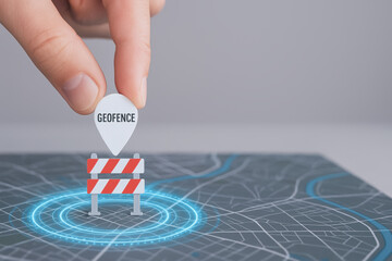 Geofence technology concept with hand placing location marker on digital map for emergency zone alert and safety control