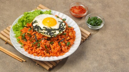 Kimchi bokkeumbap (kimchi fried rice) is a Korean dish consisting of rice fried with kimchi.